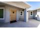 Inviting front entrance with a decorative door, textured walls, and a covered porch area at 714 Lacy Ln, Las Vegas, NV 89107