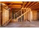 Unfinished room features stairs and wood framework offering potential for design at 714 Lacy Ln, Las Vegas, NV 89107