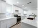 Bright kitchen with stainless steel appliances, island, and white cabinetry at 714 Lacy Ln, Las Vegas, NV 89107