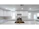 Modern kitchen features white cabinetry, stainless steel appliances and a large island with seating at 714 Lacy Ln, Las Vegas, NV 89107