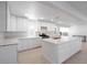 Updated kitchen features white cabinets, stainless steel appliances, and quartz countertops at 714 Lacy Ln, Las Vegas, NV 89107