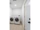 This laundry room has a white washer and dryer and a white door at 714 Lacy Ln, Las Vegas, NV 89107
