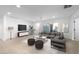 Bright living room with a large gray couch, modern furniture, light colored wood floors, and recessed lighting at 714 Lacy Ln, Las Vegas, NV 89107