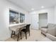 Bright home office with light wood floors, neutral armchairs, a rustic desk, and lots of natural light at 714 Lacy Ln, Las Vegas, NV 89107