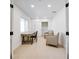 Bright home office with light wood floors, neutral armchairs, a rustic desk, and lots of natural light at 714 Lacy Ln, Las Vegas, NV 89107