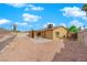 View of the backyard, featuring a gravel area, patio, and the home's exterior at 7274 Pinebrook Cir, Las Vegas, NV 89147