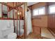 Cozy bathroom featuring wood paneling, unique window and shower at 7274 Pinebrook Cir, Las Vegas, NV 89147