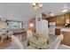 Open-concept living space with dining area, wood floors, white appliances, and a view to the living room at 7274 Pinebrook Cir, Las Vegas, NV 89147