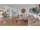 Bright living room featuring wood floors, white walls, and an open floor plan at 7274 Pinebrook Cir, Las Vegas, NV 89147