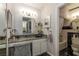 Bathroom featuring granite counters, round mirror, marble flooring, and a view of the shower and tub at 730 S Royal Crest Cir # 424, Las Vegas, NV 89169