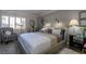 Cozy bedroom with modern decor, plush bedding, and an accent chair with natural light from bright windows at 730 S Royal Crest Cir # 424, Las Vegas, NV 89169