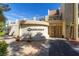 Exterior view of the Casablanca building entrance, a modern facade with desert landscaping and stone planters at 730 S Royal Crest Cir # 424, Las Vegas, NV 89169