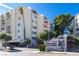 Condominium complex featuring a well-maintained sign, mature landscaping, and inviting architecture at 730 S Royal Crest Cir # 424, Las Vegas, NV 89169