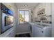 Laundry room including appliances, a window, and storage space at 730 S Royal Crest Cir # 424, Las Vegas, NV 89169