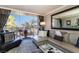 Inviting living room featuring a plush sectional sofa, balcony, and a serene outdoor view at 730 S Royal Crest Cir # 424, Las Vegas, NV 89169