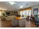 Bright living room featuring tile floors, neutral paint, seating areas, and a workspace at 730 S Royal Crest Cir # 424, Las Vegas, NV 89169