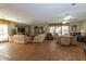 Spacious living room with tile floors, comfortable couches, and a large window letting in natural light at 730 S Royal Crest Cir # 424, Las Vegas, NV 89169