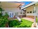 Outdoor view of backyard space complete with artificial turf, low-maintenance landscaping, and an outdoor seating area at 7565 N Torrey Pines Dr # A, Las Vegas, NV 89131