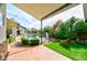 Spacious backyard featuring artificial turf, privacy hedges, pool with safety fence, patio and lush landscaping at 7565 N Torrey Pines Dr # A, Las Vegas, NV 89131