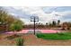 Landscaped basketball court area featuring custom court art, bench, and a swing set at 7565 N Torrey Pines Dr # A, Las Vegas, NV 89131