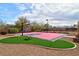 Outdoor basketball court featuring custom court art, manicured landscaping, and a swing set at 7565 N Torrey Pines Dr # A, Las Vegas, NV 89131
