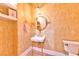 Unique powder room with gold fixtures, eye-catching mirror, and decorative wallpaper at 7565 N Torrey Pines Dr # A, Las Vegas, NV 89131