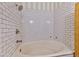 Bathroom with subway tile walls, soaking tub, and chrome fixtures at 7565 N Torrey Pines Dr # A, Las Vegas, NV 89131