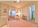 Bright Bedroom with pink rug, cribs, and cozy reading nook at 7565 N Torrey Pines Dr # A, Las Vegas, NV 89131