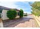 Wide, paved driveway leading to a home with beautiful desert landscaping and red tile roof at 7565 N Torrey Pines Dr # A, Las Vegas, NV 89131