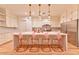 Modern kitchen features white cabinets, stainless steel appliances, marble backsplash, and a large kitchen island at 7565 N Torrey Pines Dr # A, Las Vegas, NV 89131