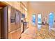 Modern kitchen featuring stainless steel appliances, granite counters, and access to the outdoor living space at 7565 N Torrey Pines Dr # A, Las Vegas, NV 89131