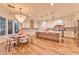 Bright kitchen boasts wood floors, white cabinets, marble counters, large island, and chandelier at 7565 N Torrey Pines Dr # A, Las Vegas, NV 89131