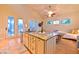 Open-concept kitchen with granite counters, stainless appliances, island, and seamless indoor-outdoor flow at 7565 N Torrey Pines Dr # A, Las Vegas, NV 89131