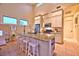 Spacious kitchen island with seating, granite countertops, stainless steel appliances, and ample cabinet space at 7565 N Torrey Pines Dr # A, Las Vegas, NV 89131