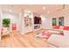 Bright living room features built-in shelving, a marble fireplace, wood flooring, and a comfortable seating area at 7565 N Torrey Pines Dr # A, Las Vegas, NV 89131