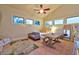 Bright living area featuring large windows, a cozy couch, a table, and stylish decor at 7565 N Torrey Pines Dr # A, Las Vegas, NV 89131