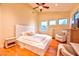 Inviting main bedroom showcasing natural light, vaulted ceiling with ceiling fan, and a cozy sitting area at 7565 N Torrey Pines Dr # A, Las Vegas, NV 89131