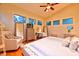 Relaxing bedroom featuring natural light, vaulted ceiling with fan, seating, and ample closet space at 7565 N Torrey Pines Dr # A, Las Vegas, NV 89131