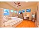 Serene main bedroom boasting large windows, a ceiling fan, and ample space for relaxation and decor at 7565 N Torrey Pines Dr # A, Las Vegas, NV 89131