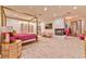 A luxurious main bedroom with fireplace, herringbone floors, sitting area, and soft lighting at 7565 N Torrey Pines Dr # A, Las Vegas, NV 89131