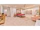 A stylish main bedroom featuring a four-poster bed, herringbone floors, and decorative art at 7565 N Torrey Pines Dr # A, Las Vegas, NV 89131