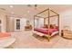 This main bedroom has a four-poster bed, plush furnishings, and a cozy rug at 7565 N Torrey Pines Dr # A, Las Vegas, NV 89131