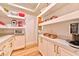 Walk-in pantry area with white cabinets, marble counters, and open shelving at 7565 N Torrey Pines Dr # A, Las Vegas, NV 89131