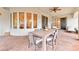Covered patio features a large table with seating, ceiling fan, and sliding glass doors that lead to the interior space at 7565 N Torrey Pines Dr # A, Las Vegas, NV 89131