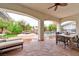 Covered patio with outdoor seating and views of the pool and landscaped backyard at 7565 N Torrey Pines Dr # A, Las Vegas, NV 89131