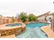 Backyard view showcases a built-in spa cascading into a pool with lush greenery all around for maximum privacy at 7565 N Torrey Pines Dr # A, Las Vegas, NV 89131