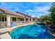 A beautiful pool with a diving board, lush trees, -safe fence, and a built-in spa are just a few highlights at 7565 N Torrey Pines Dr # A, Las Vegas, NV 89131