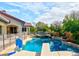 Inviting backyard pool and spa area surrounded by lush landscaping, diving board and safety fence at 7565 N Torrey Pines Dr # A, Las Vegas, NV 89131