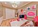 Walk-in closet with custom cabinets, desk, and pink accents at 7565 N Torrey Pines Dr # A, Las Vegas, NV 89131