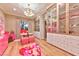 Bright walk-in closet featuring glass cabinets, chandelier, and pink accents at 7565 N Torrey Pines Dr # A, Las Vegas, NV 89131